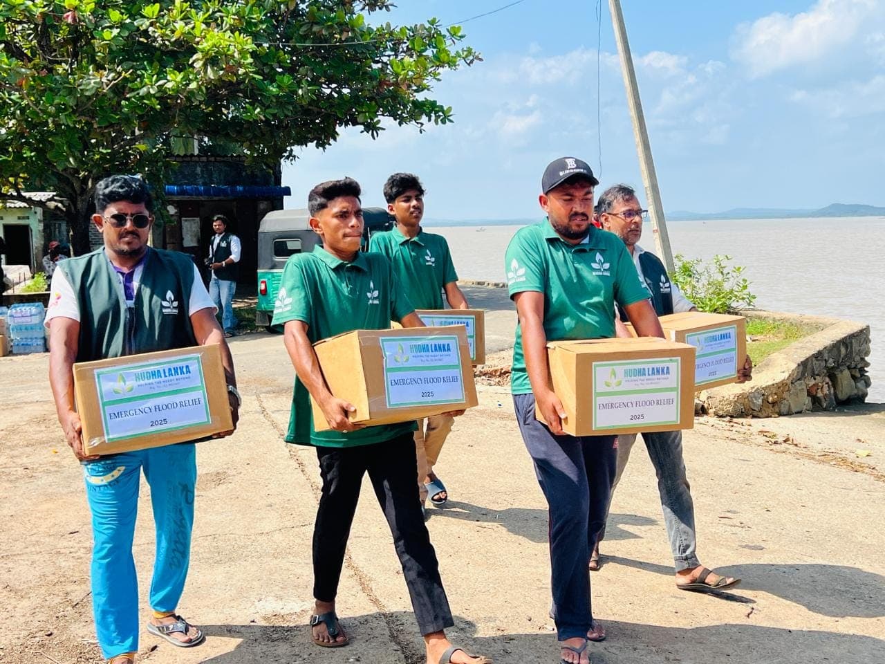 Volunteers carrying food relief boxes to families in Sri Lanka