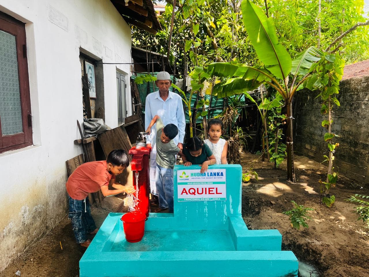 Children washing at a newly installed hand pump in Trincomalee, Sri Lanka