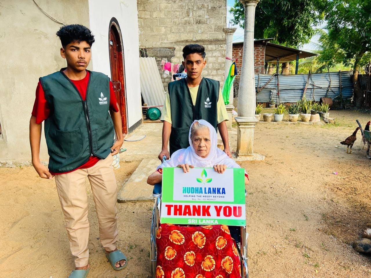 An elderly woman with the wheelchair delivered to her home in Sri Lanka